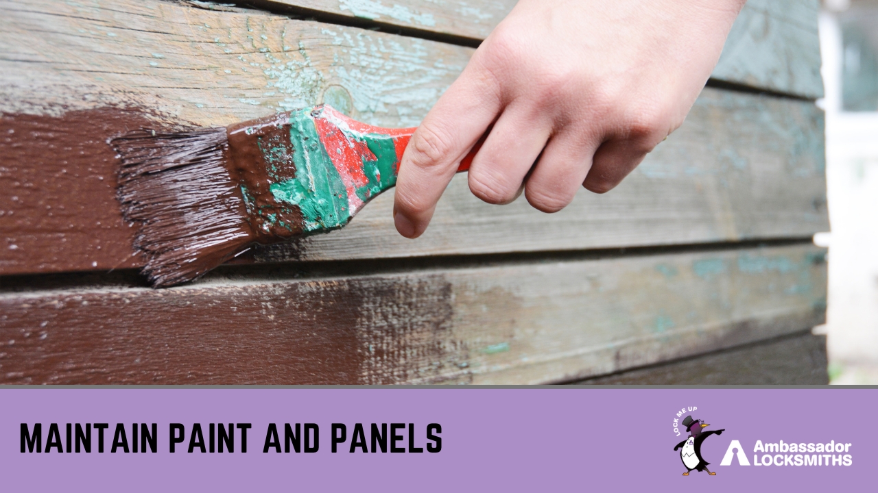 Person applying exterior paint to wooden shed panels to prevent weather damage and maintain strength