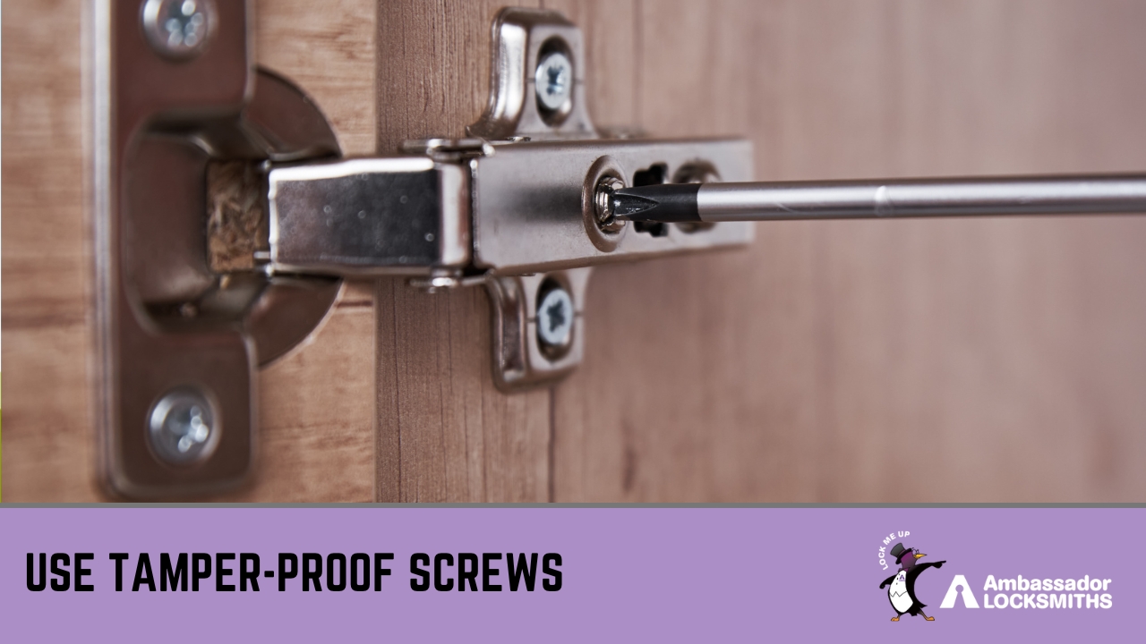 Close-up of person securing garden shed hinge with anti-theft screws