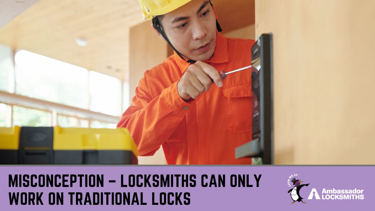 A male locksmith or technician, wearing a yellow hard hat and an orange long-sleeved shirt, is focused on using a screwdriver to install a modern black digital lock onto a wooden door.
